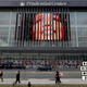 People walk past a large image of Whitney Houston displayed on the side of the Prudential Center in Newark, N.J., Feb. 14, 2012. Officials had discussed the possibility of holding a memorial at the Prudential Center, a major sports and entertainment venue that can seat about 18,000 people, but instead Houston’s homegoing was held at her home church, New Hope Baptist, in Newark. (AP Images)